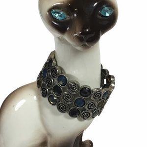 Silver toned stretchy bracelet with blue & gold